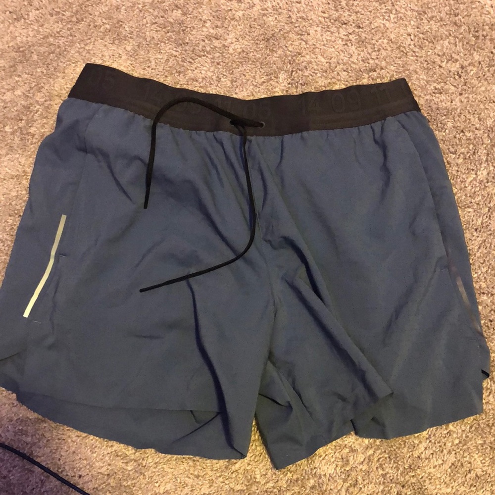 Blue Nike tech running shorts